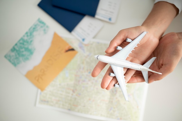 Free photo close up hands holding small plane top view