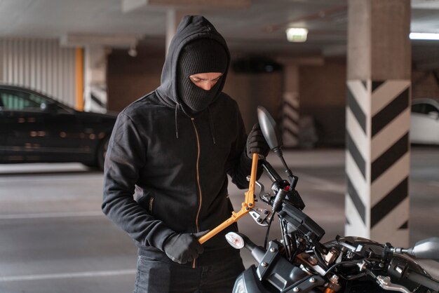 Close up on man preparing to steal a motorcycle