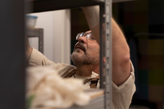 Close up man in storage closet