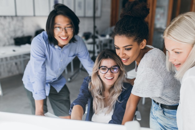 Free photo close-up portrait of freelance it-specialists looking at laptop screen with smile