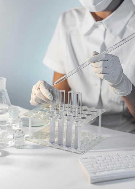 Free Photo close-up researcher holding pipette and tube