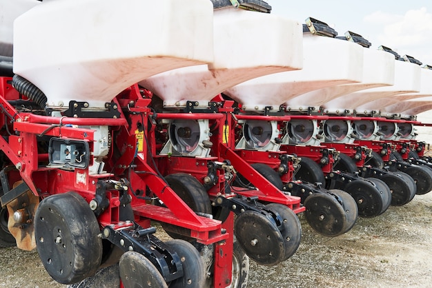 Free Photo close up of seeder attached to tractor in field.