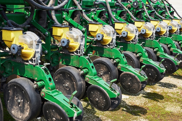 Free Photo close up of seeder attached to tractor in field.