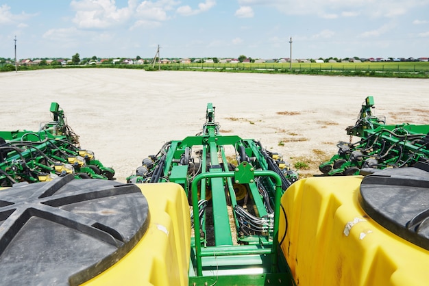 Free Photo close up of seeder attached to tractor in field.