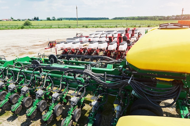 Free Photo close up of seeder attached to tractor in field.