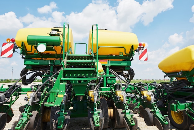 Free Photo close up of seeder attached to tractor in field.