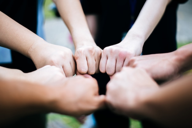 Free photo close up of students standing hands making fist bump gesture.