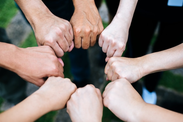 Free photo close up of students standing hands making fist bump gesture.