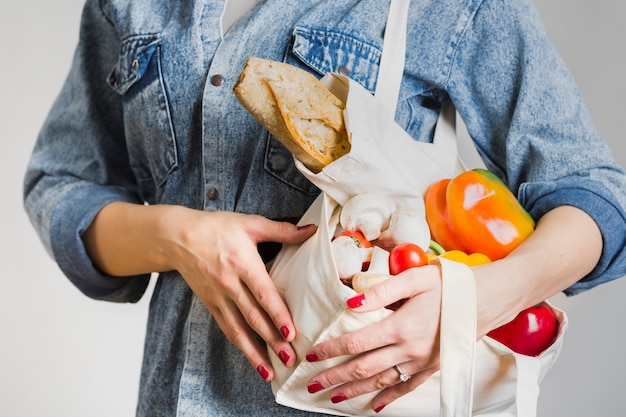 Free photo close-up woman holding fresh and organic products