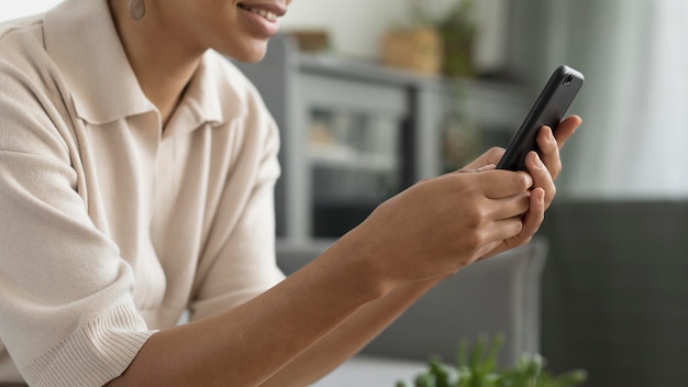 Free photo close up woman holding phone