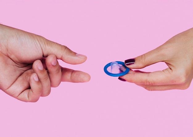 Free photo close-up woman and man with blue condom