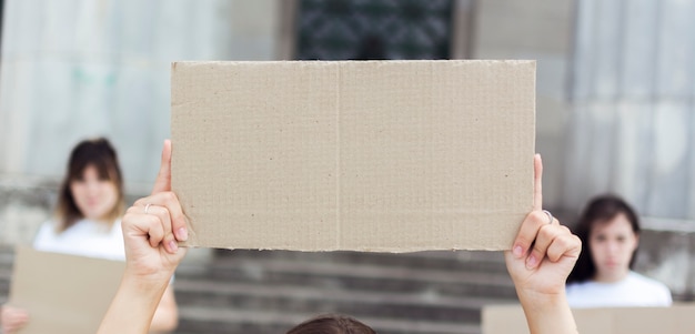 Free Photo close-up women holding cardboard signs at protest