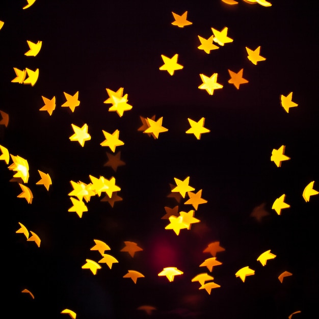 Free photo close-up yellow stars on dark