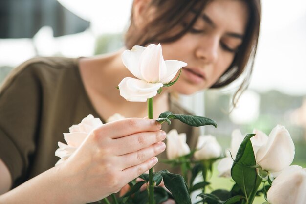 Closeup a bouquet of roses in the hands of a female florist