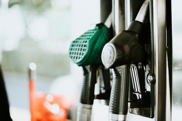 Free photo closeup of fuel nozzles at a gas station