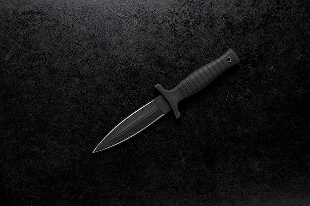 Free photo closeup shot of a fixed sharp knife on a black background