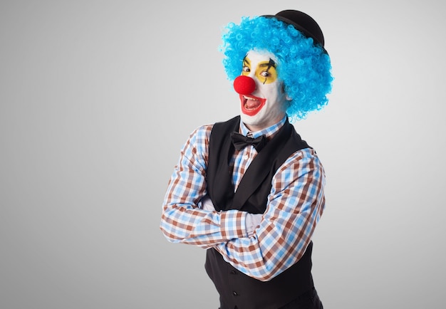 Clown with crossed arms making funny faces