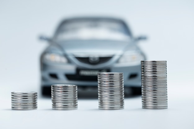 Free Photo coin stacks in front of car