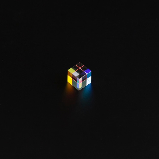 Free photo colored cube prism in the dark