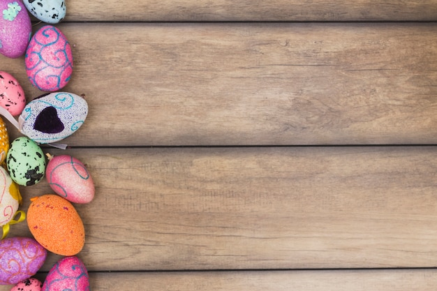 Free photo colored eggs on wooden background