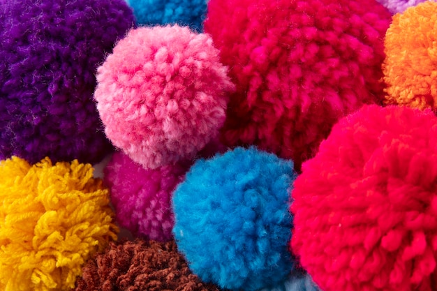 Colorful pom poms arrangement flat lay