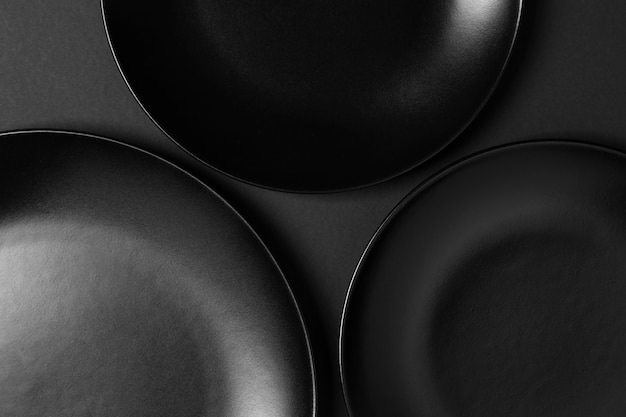 Free photo composition of black plates on black background