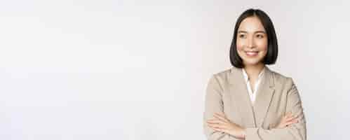 Free photo confident female entrepreneur asian business woman standing in power pose professional business person cross arms on chest standing over white background