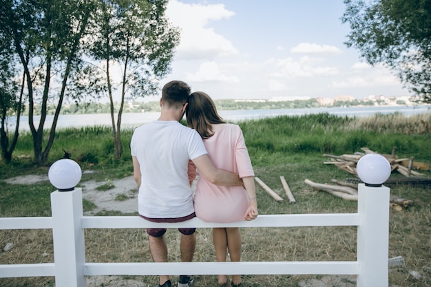 Free photo couple of backs sitting on a white fence