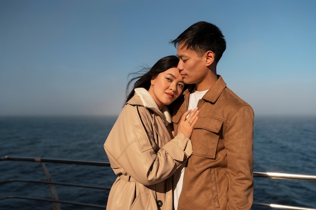 Free photo couples embracing near the sea