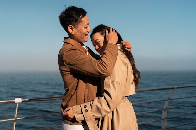 Free photo couples embracing near the sea