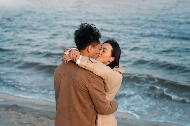 Free photo couples embracing near the sea