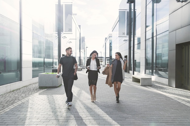 Free photo coworkers walking on street