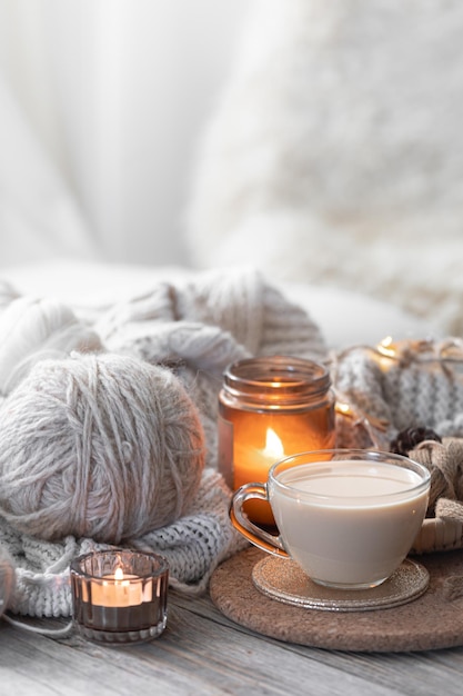 Free photo a cozy composition with threads a candle and a cup of coffee hobby and home comfort concept