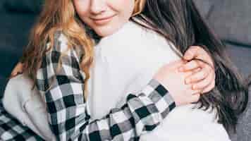 Free photo crop females hugging at home