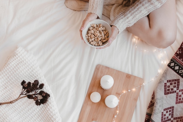 Free photo crop woman with snack on bed