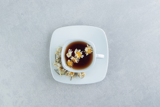 Free photo cup of tea with dried chamomile flowers.