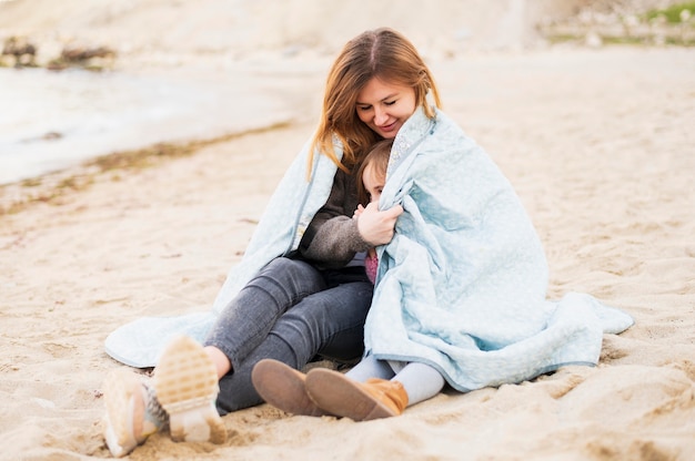 Free photo cute girl and mother snuggling