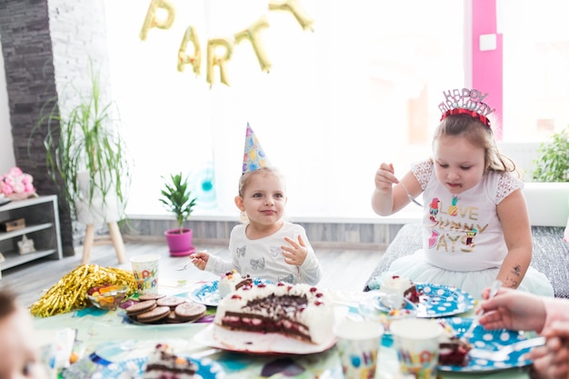 Free photo cute girls eating cake