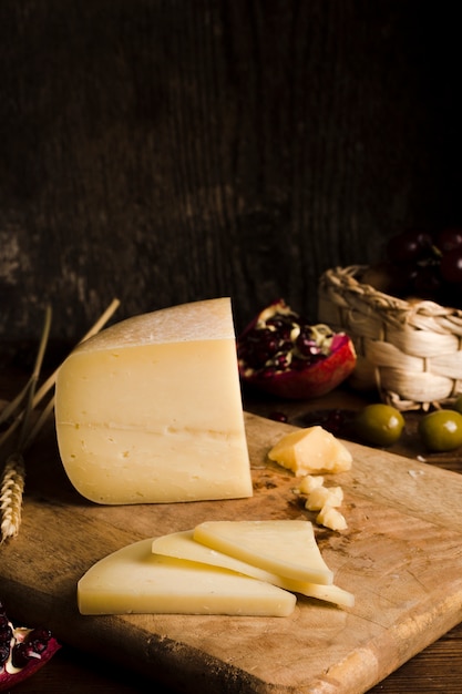 Delicious buffet with cheese on wooden board