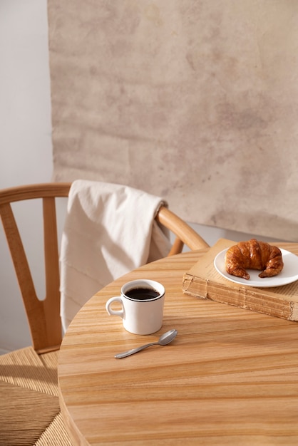 Free photo delicious croissant on wooden table high angle