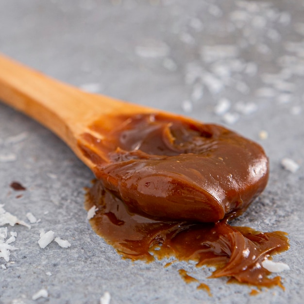 Free photo delicious dulche de leche on spoon  concept