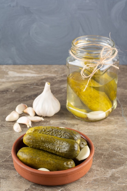 Free Photo delicious marinated pickled cucumbers with fresh garlic .