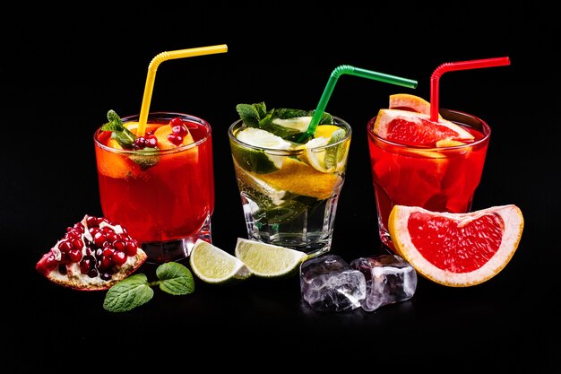 Delicious mojito, rum and cola, blood orange and vodka cocktails served with fruit