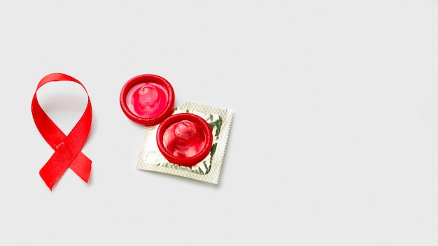 Different condoms on white background with copy space