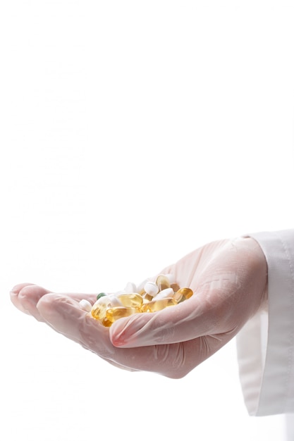 Free photo doctor holding heap of pills