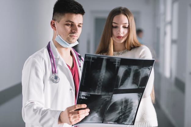 Free photo doctor and patient watching x-ray