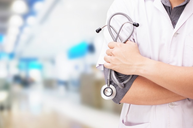Free photo doctor with a stethoscope in the hands and hospital background