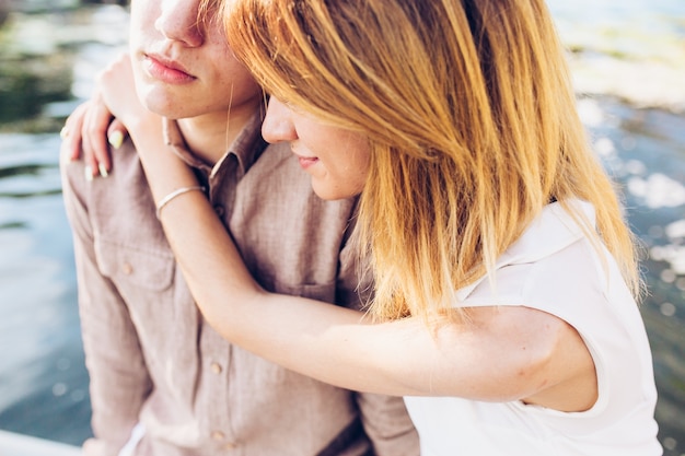 Free photo dreamy young couple cuddling