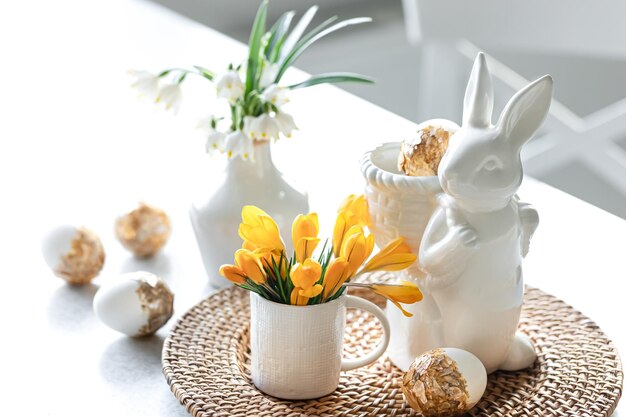 Free Photo easter still life with a ceramic hare eggs and flowers