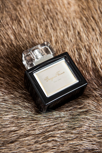 Free Photo eau de parfum fragrance bottle on a fluffy blanket